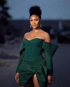 Osas Ighodaro, co-host at the One Africa Music Festival 2021, in a green dress